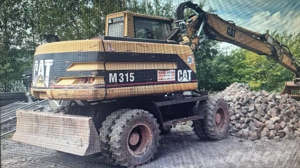 CAT M 315 Ekskavatori uz riteņiem
