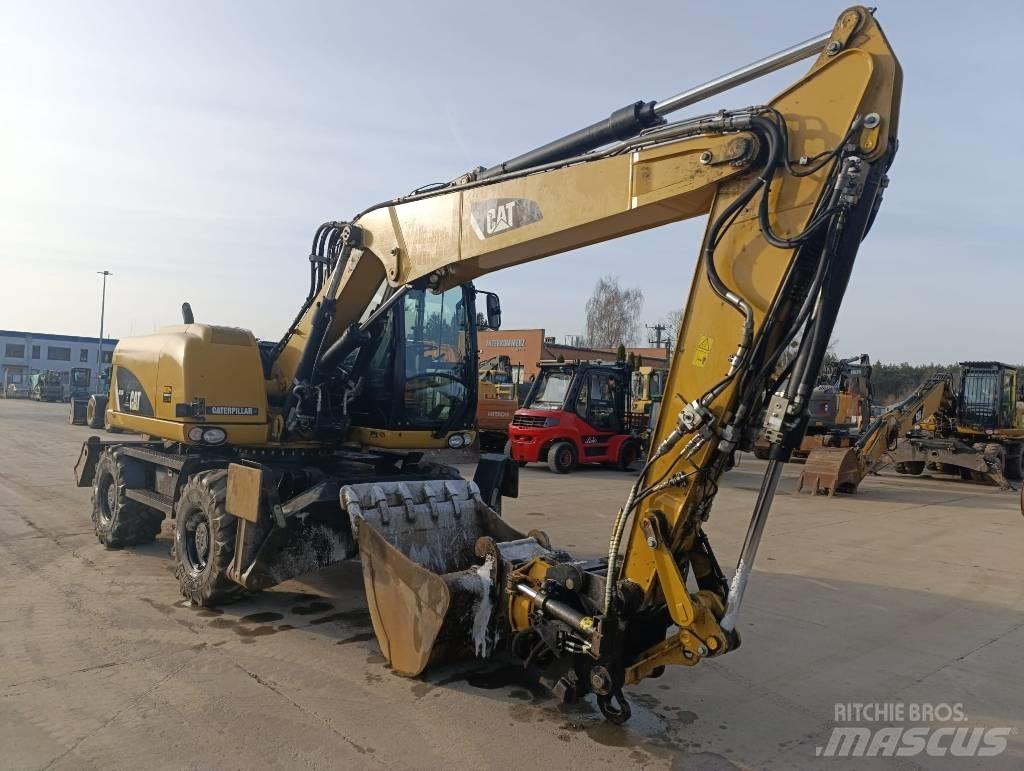 CAT M 313 D Ekskavatori uz riteņiem