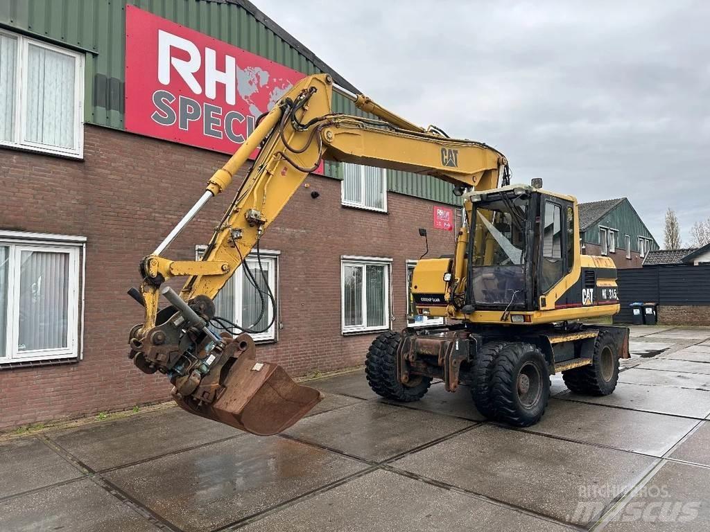 CAT M315 +ROTO CE Ekskavatori uz riteņiem