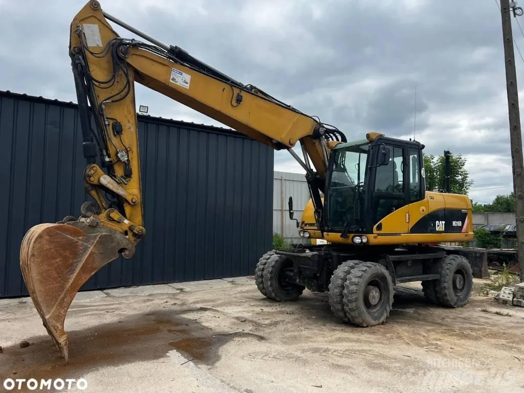 CAT M 316 D Ekskavatori uz riteņiem
