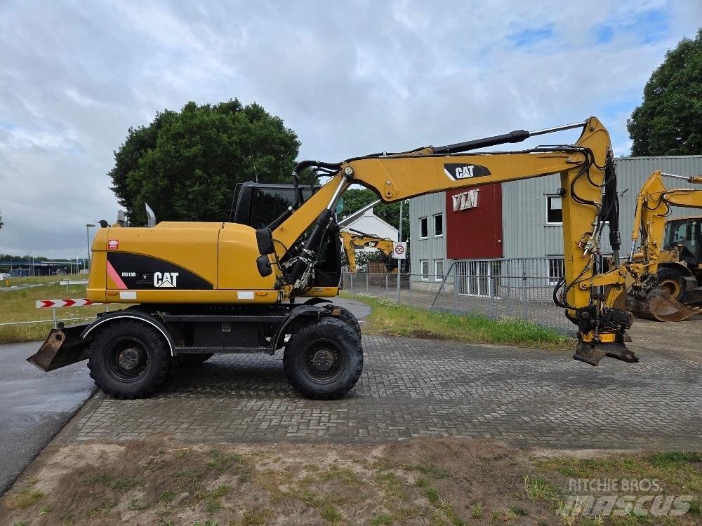 CAT M313D Ekskavatori uz riteņiem