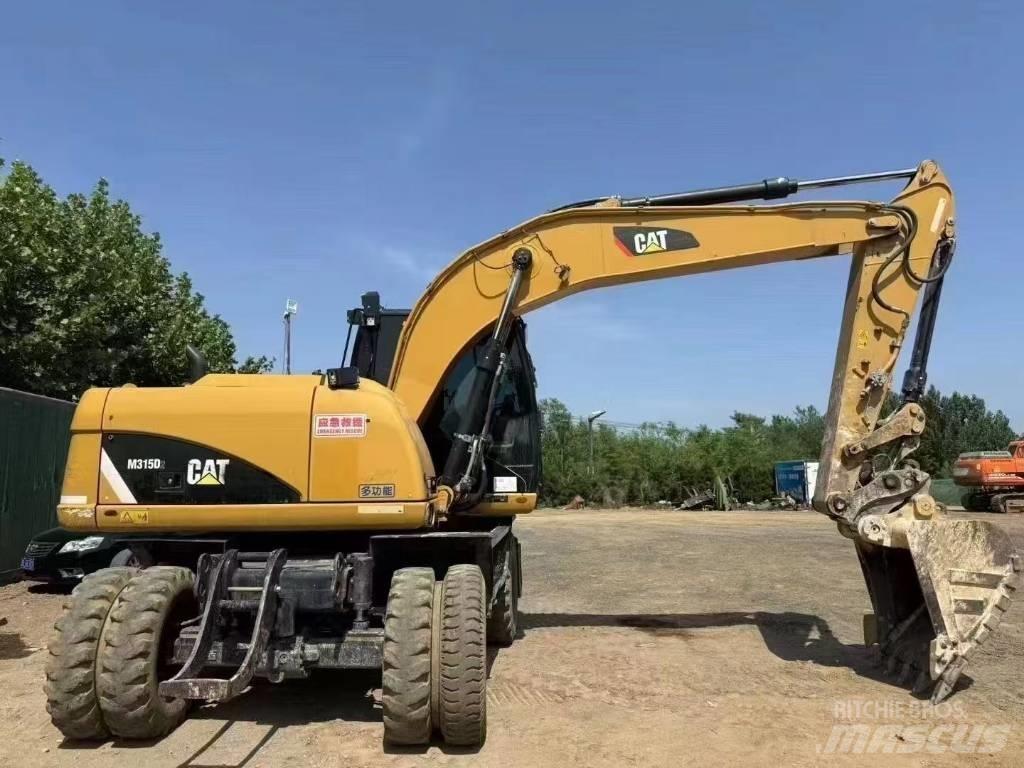 CAT M 315 D Ekskavatori uz riteņiem