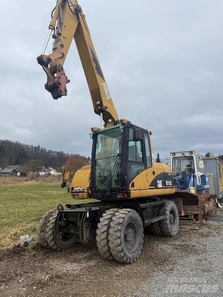 CAT M 313 C Ekskavatori uz riteņiem