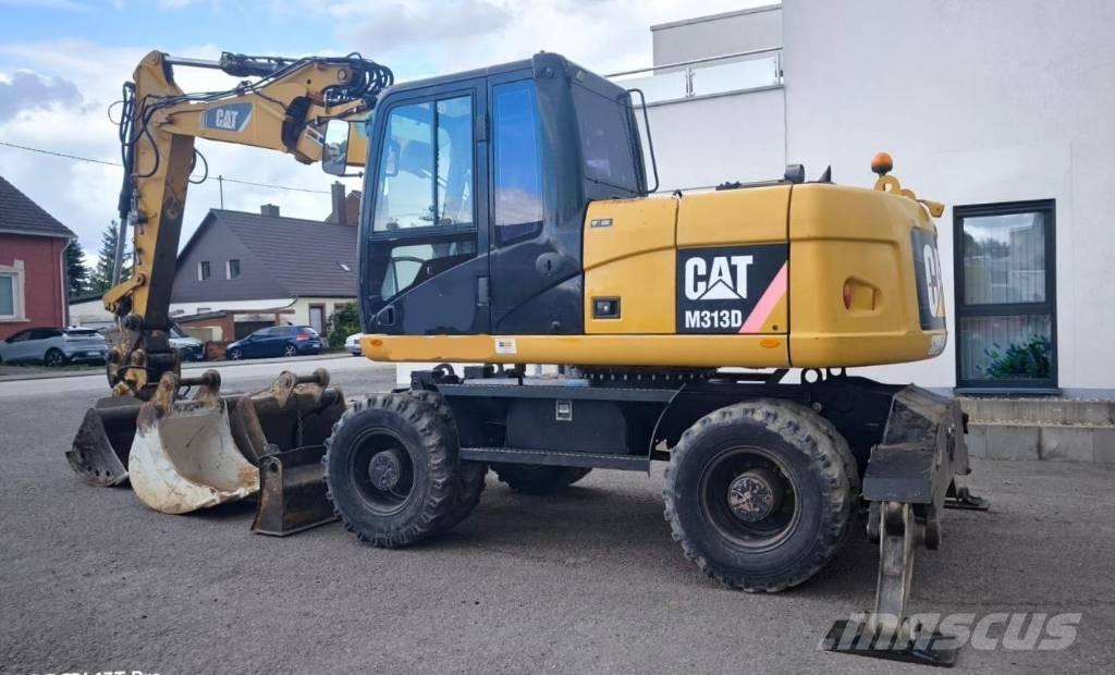 CAT M 313 D Ekskavatori uz riteņiem