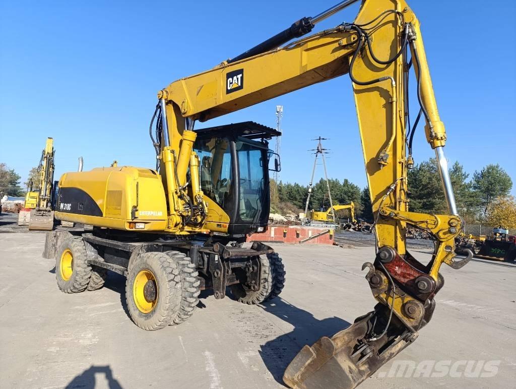 CAT M 318 C Ekskavatori uz riteņiem