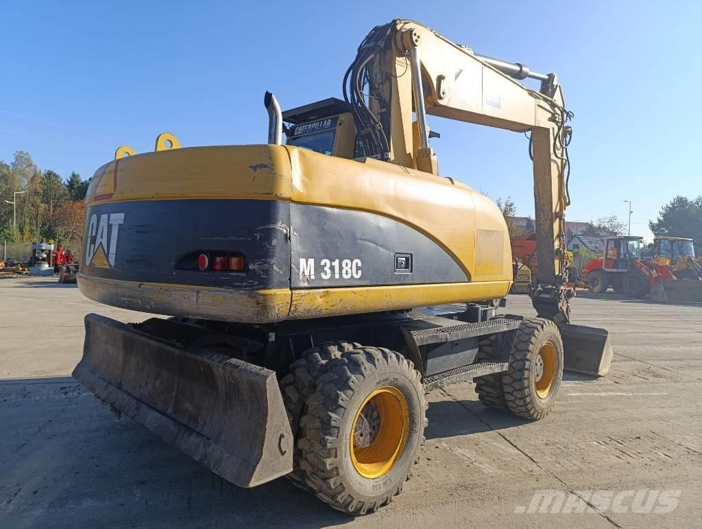 CAT M 318 C Ekskavatori uz riteņiem