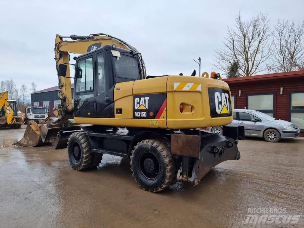 CAT M 315 D II Ekskavatori uz riteņiem