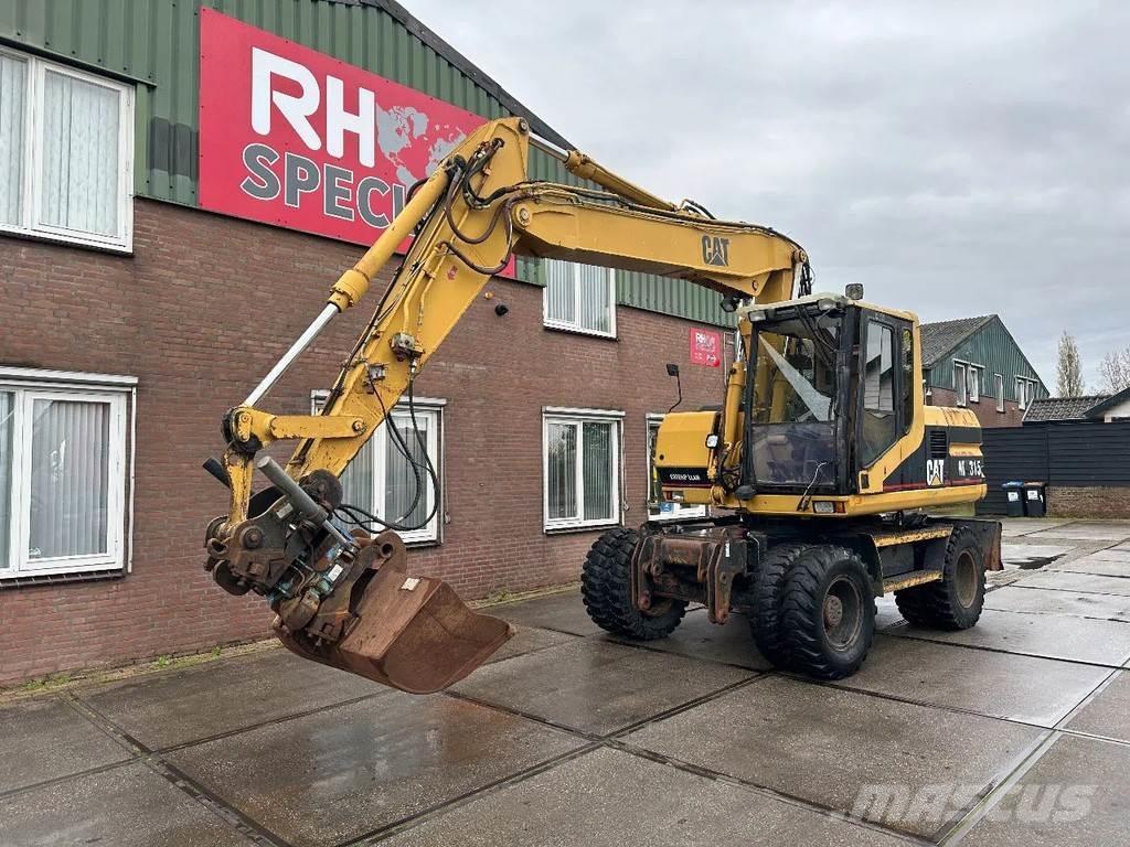 CAT M315 +ROTO CE Ekskavatori uz riteņiem