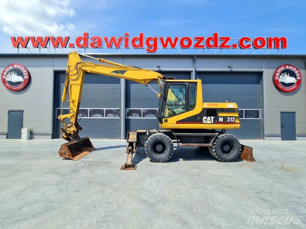 CAT M 312 Ekskavatori uz riteņiem