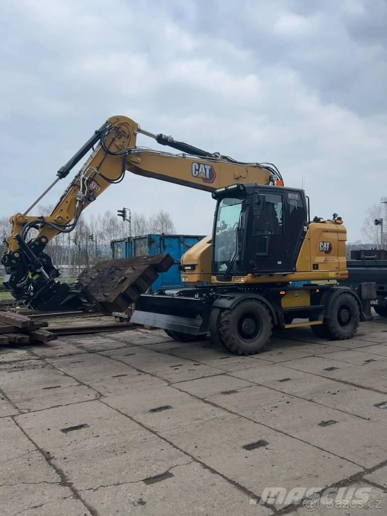 CAT M 319 Ekskavatori uz riteņiem