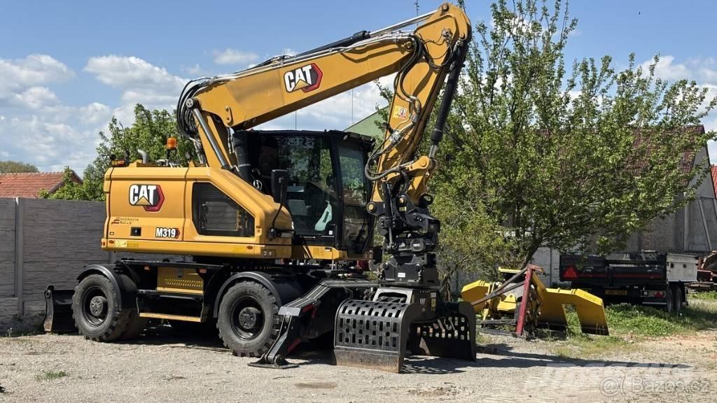 CAT M 319 Ekskavatori uz riteņiem