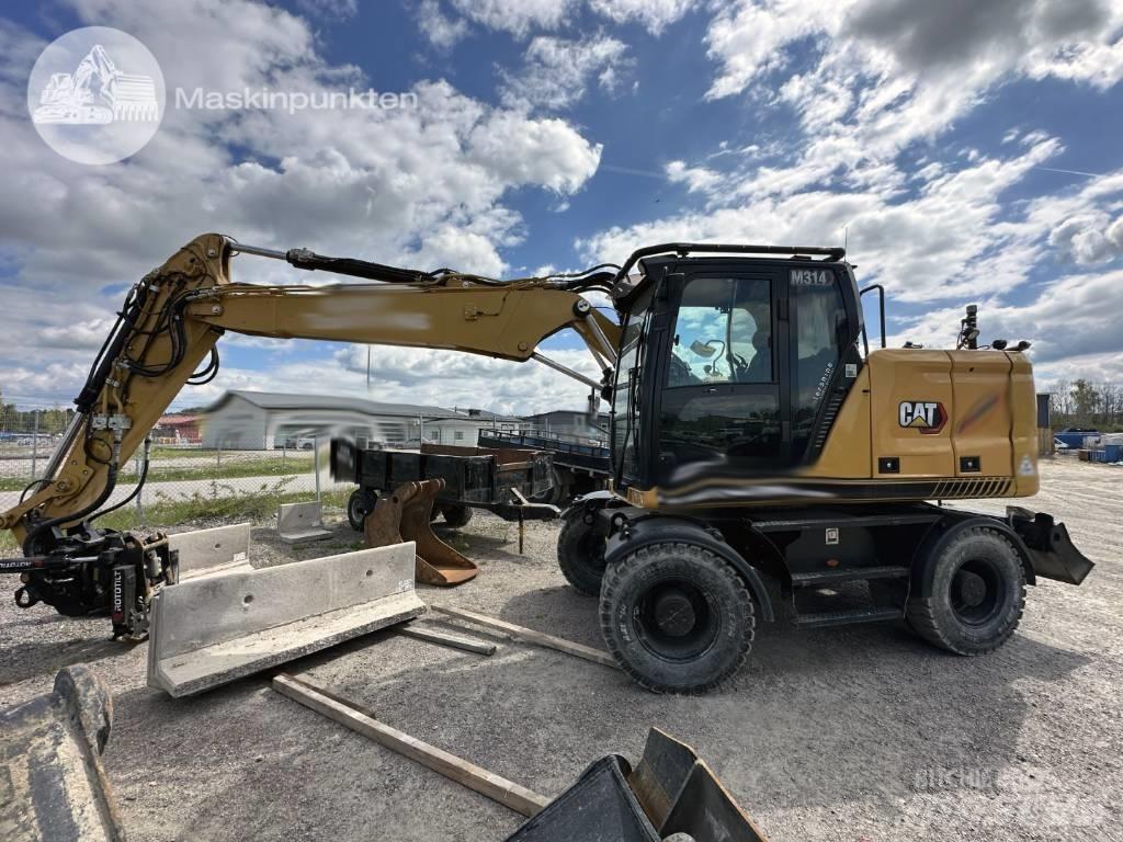 CAT M 314 Ekskavatori uz riteņiem