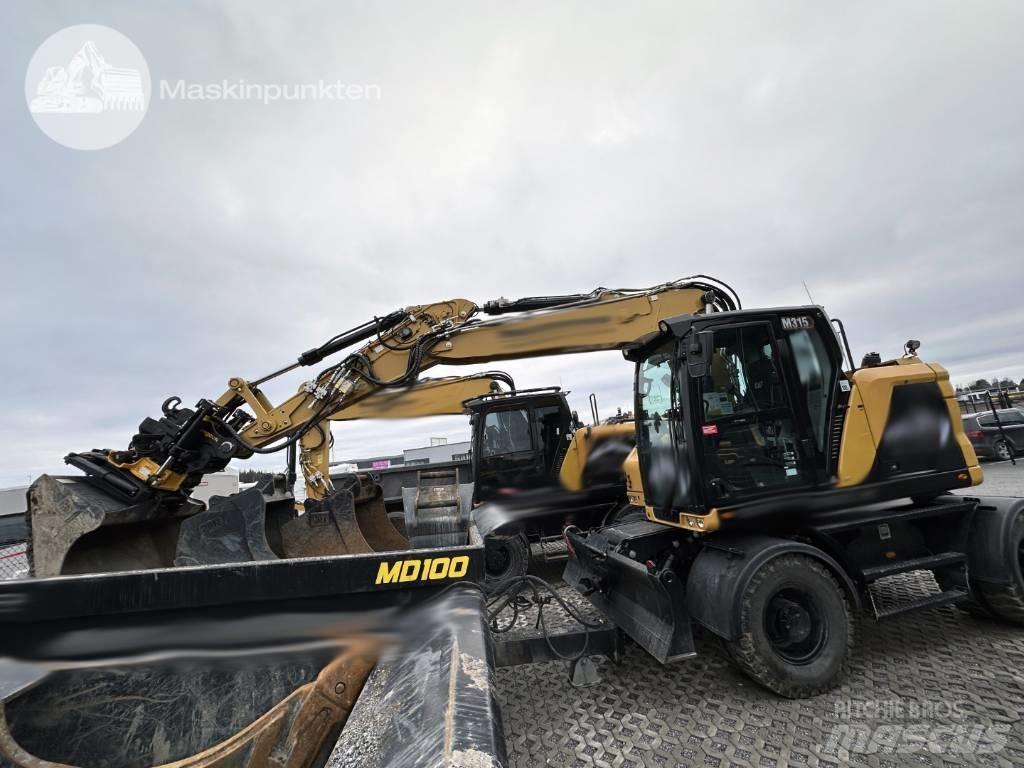 CAT M 315 Ekskavatori uz riteņiem