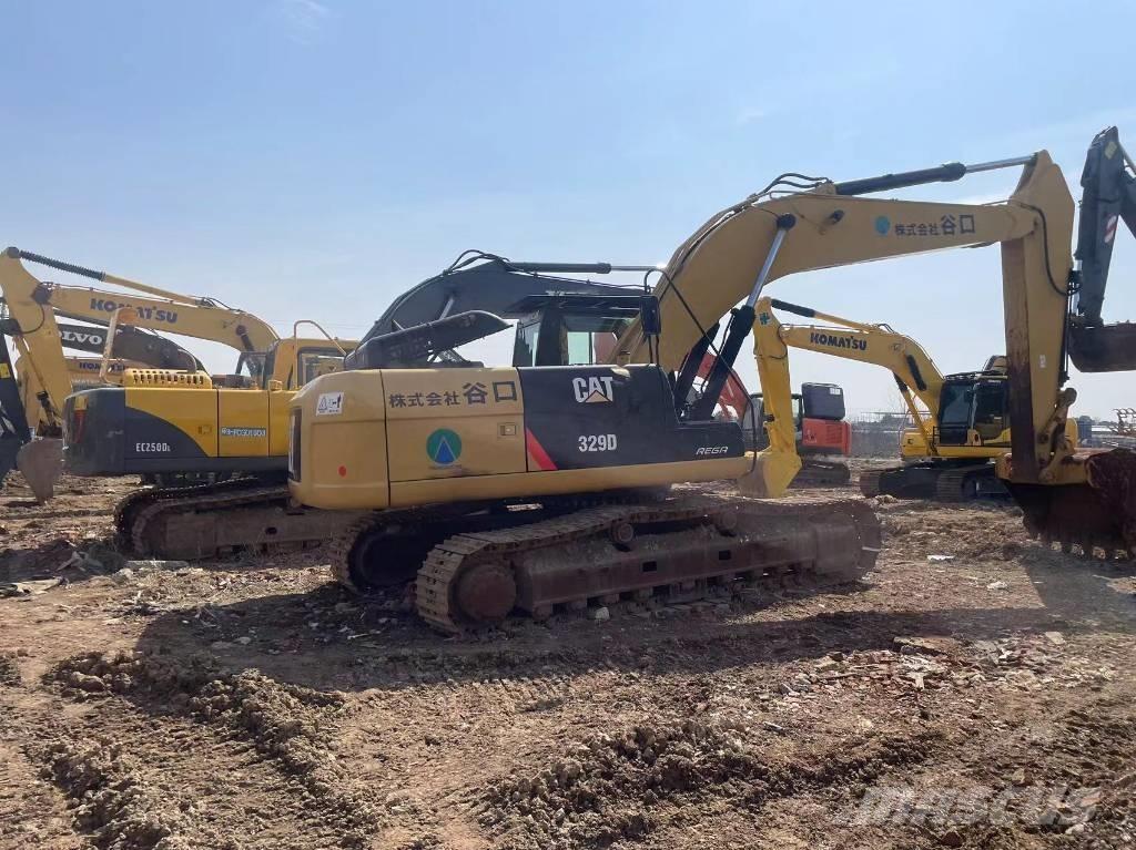 CAT 329d Ekskavatori tālās sniedzamības darbiem