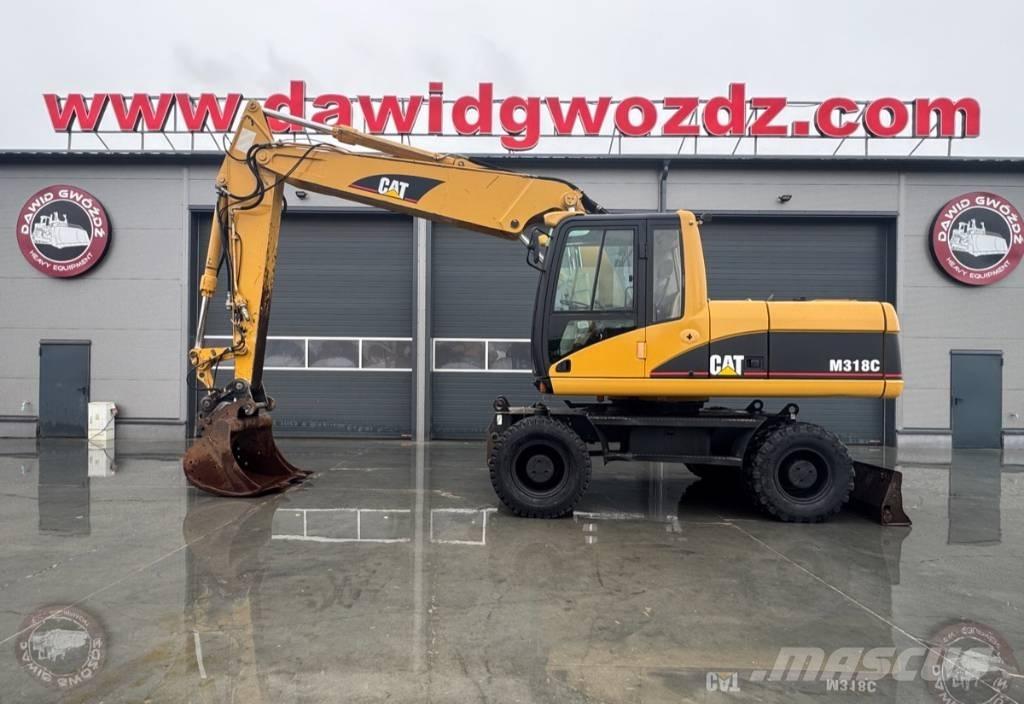 CAT M 318 C Ekskavatori uz riteņiem