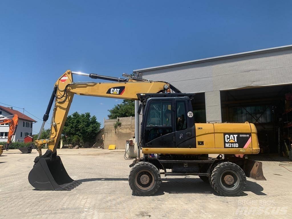 CAT M 318 D Ekskavatori uz riteņiem