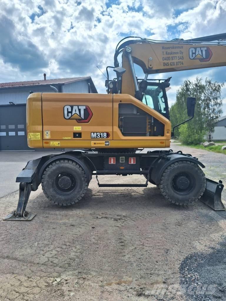 CAT M 318 Ekskavatori uz riteņiem
