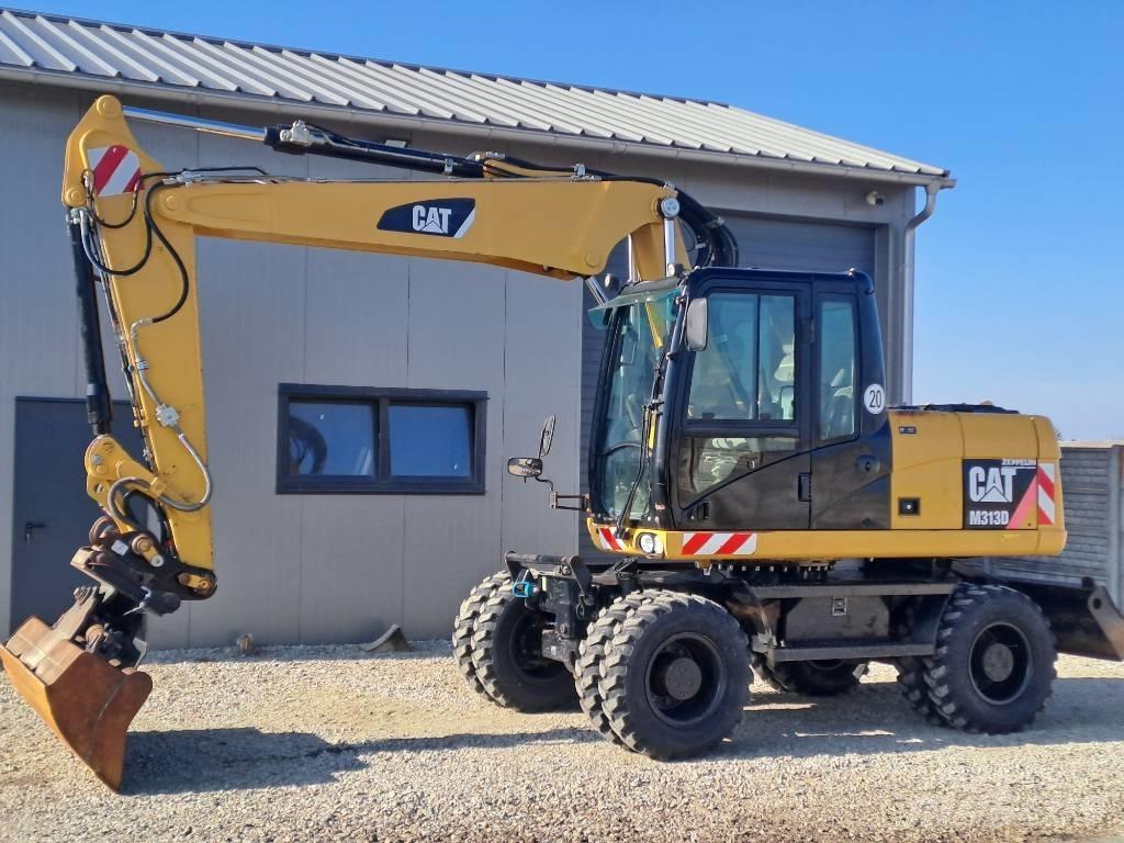 CAT M 313D Ekskavatori uz riteņiem