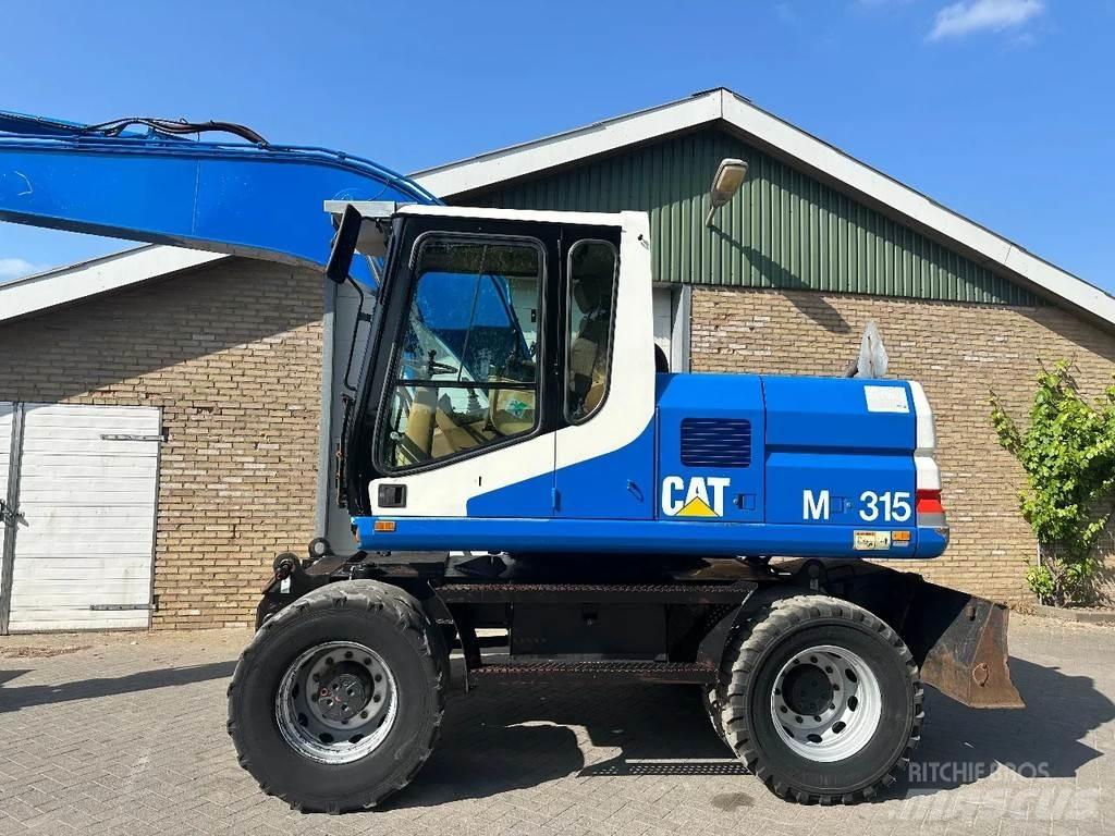 CAT M315 Ekskavatori uz riteņiem