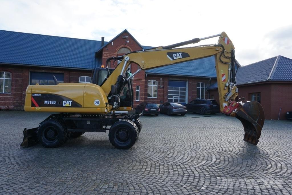 CAT M 318 D Ekskavatori uz riteņiem