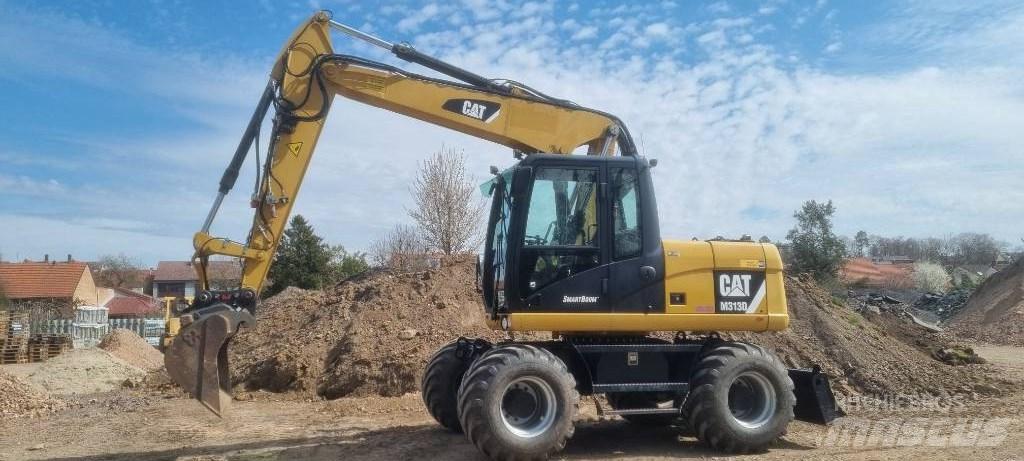CAT M 313 D Ekskavatori uz riteņiem
