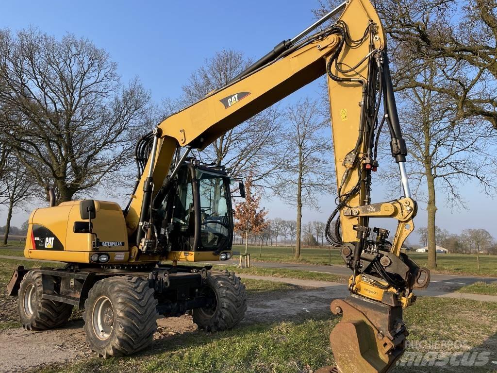 CAT M 313 D Ekskavatori uz riteņiem