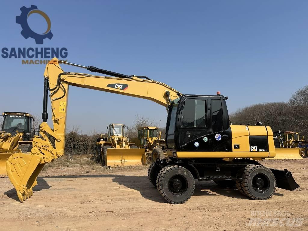 CAT M 320 D2 Ekskavatori uz riteņiem