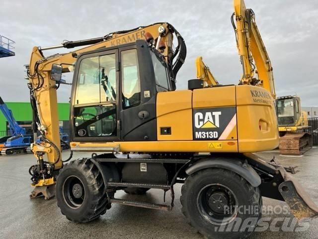 CAT M 313 D Ekskavatori uz riteņiem