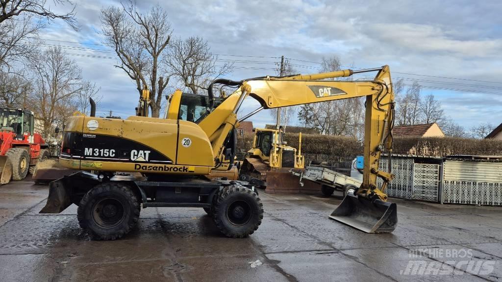 CAT M 315 C Ekskavatori uz riteņiem