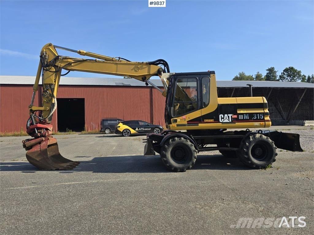 CAT M315 Ekskavatori uz riteņiem