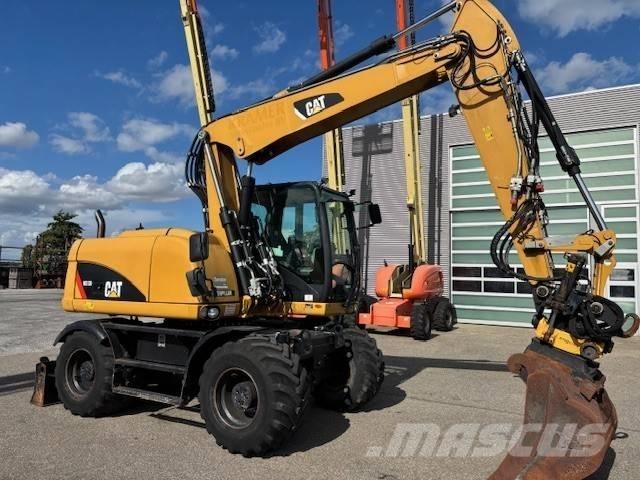 CAT M 313 D Ekskavatori uz riteņiem