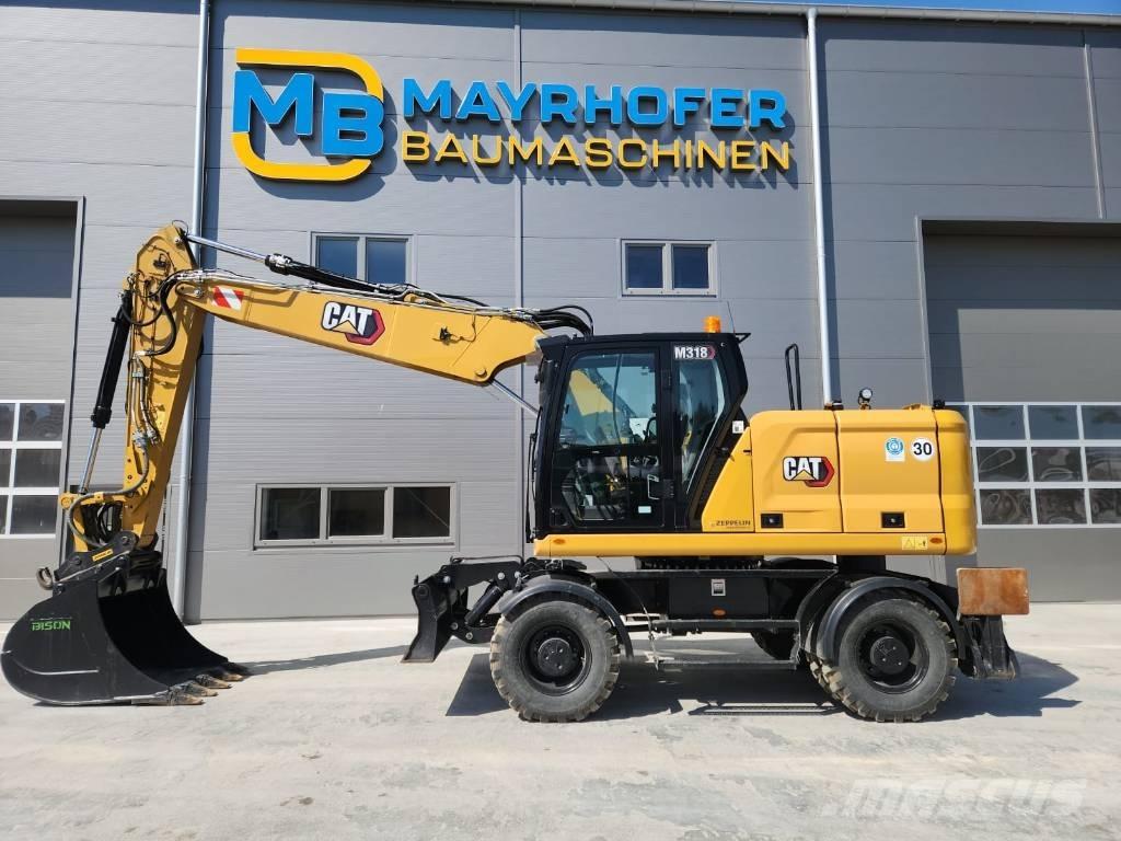 CAT M 318 Ekskavatori uz riteņiem