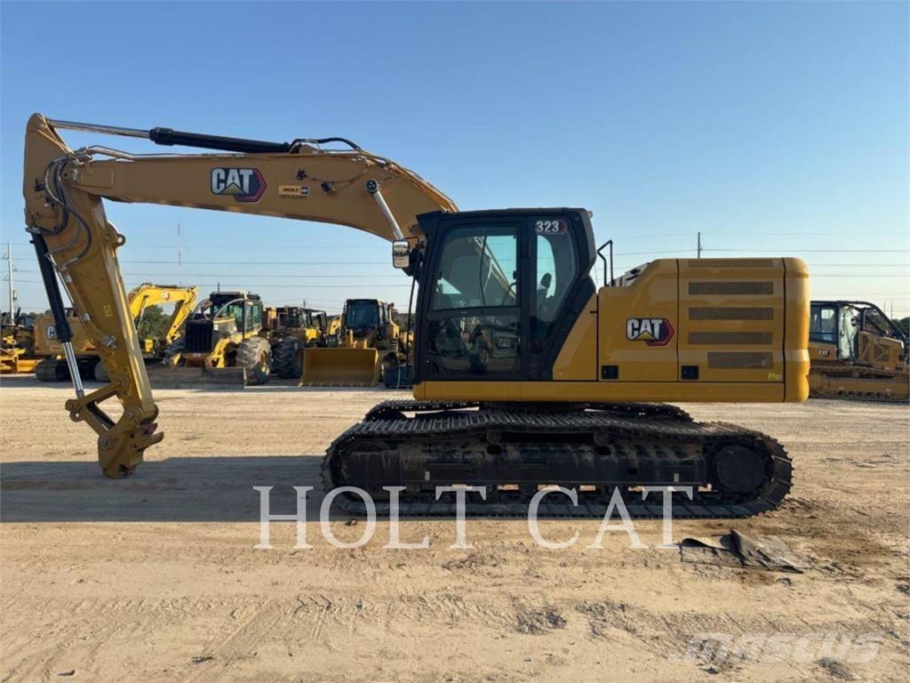 CAT 323 TC Iekrāvēji uz riteņiem