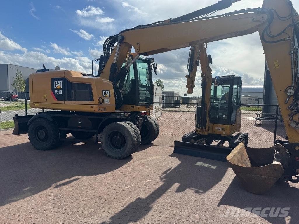 CAT 318 Ekskavatori uz riteņiem
