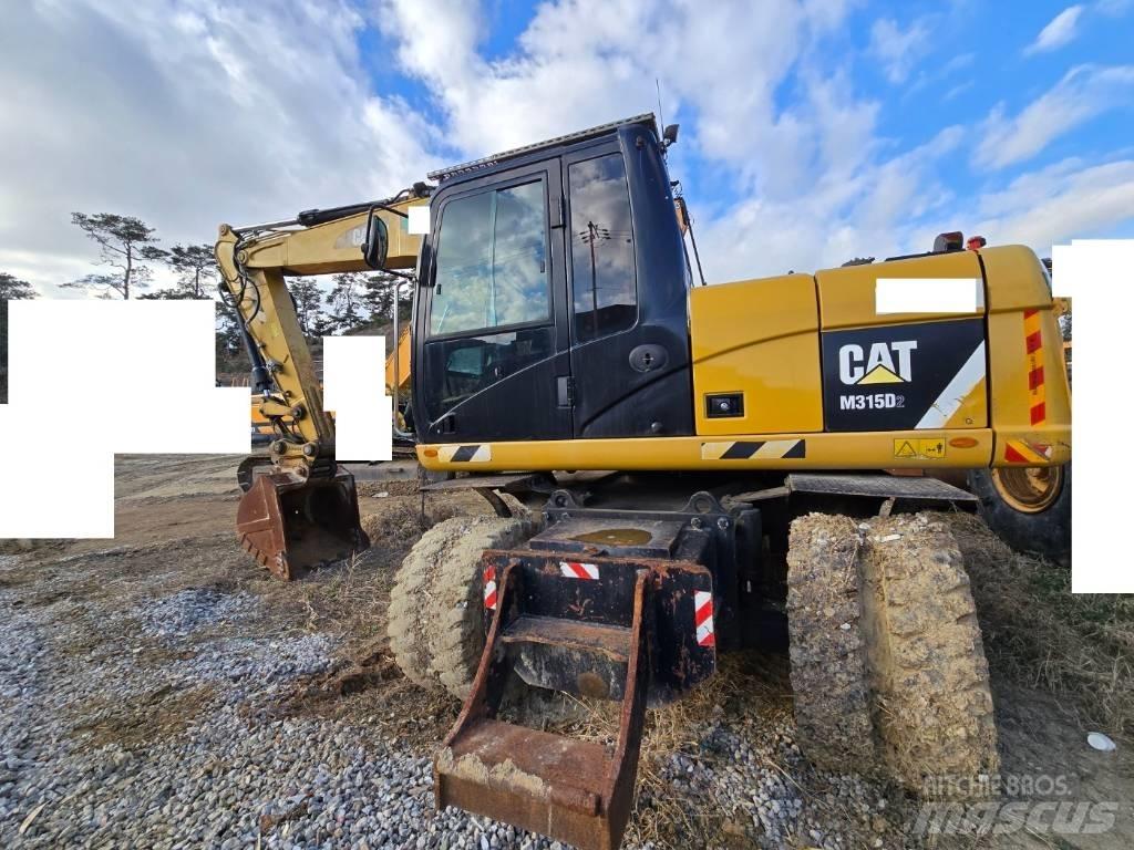 CAT M 315 D Ekskavatori uz riteņiem
