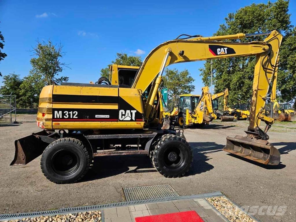 CAT M 312 Ekskavatori uz riteņiem