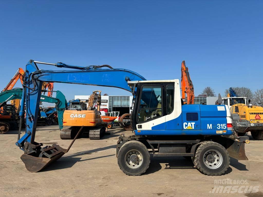 CAT M 315 Ekskavatori uz riteņiem