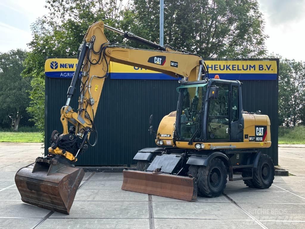 CAT M 313 D Ekskavatori uz riteņiem