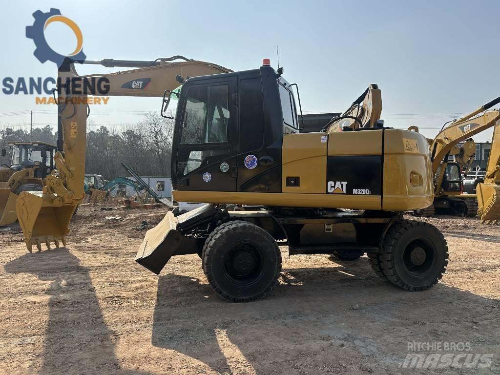 CAT M 320 D Ekskavatori uz riteņiem