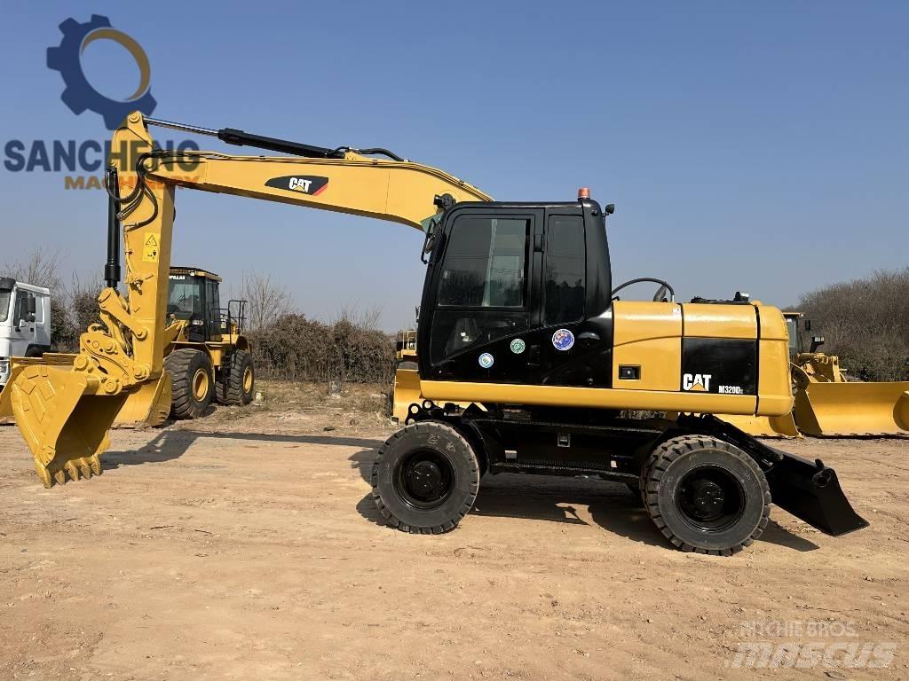 CAT M 320 D2 Ekskavatori uz riteņiem