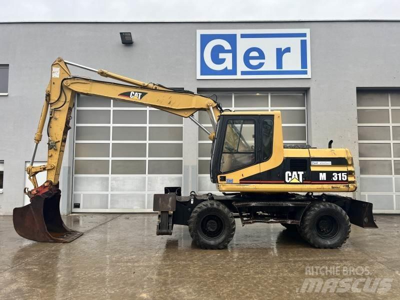 CAT M 315 Ekskavatori uz riteņiem