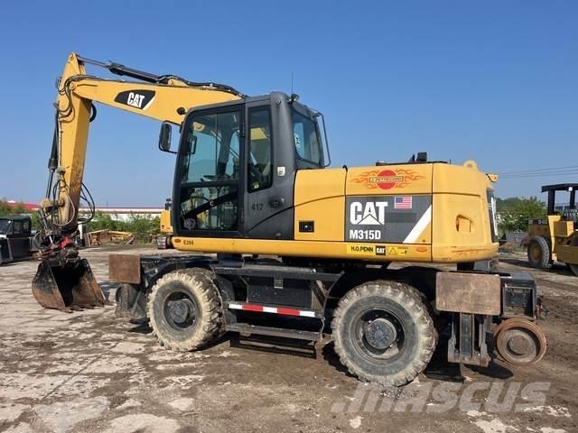 CAT M315D Ekskavatori uz riteņiem