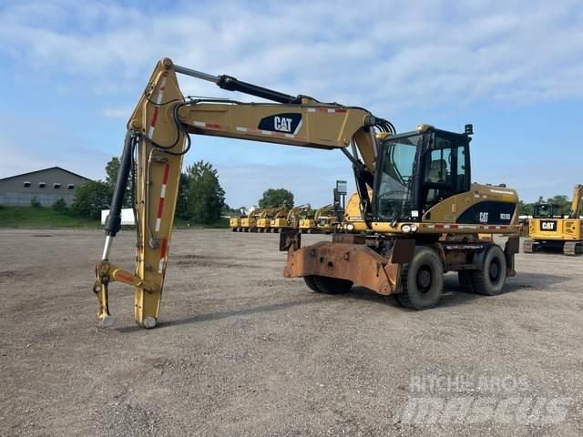 CAT M318D Ekskavatori uz riteņiem