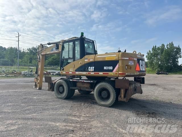 CAT M318D Ekskavatori uz riteņiem