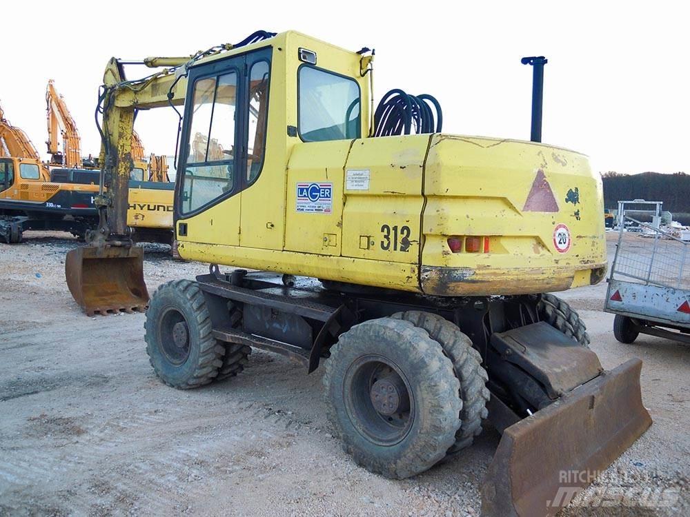 CAT M312 Ekskavatori uz riteņiem