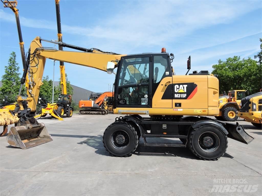 CAT M315 Ekskavatori uz riteņiem